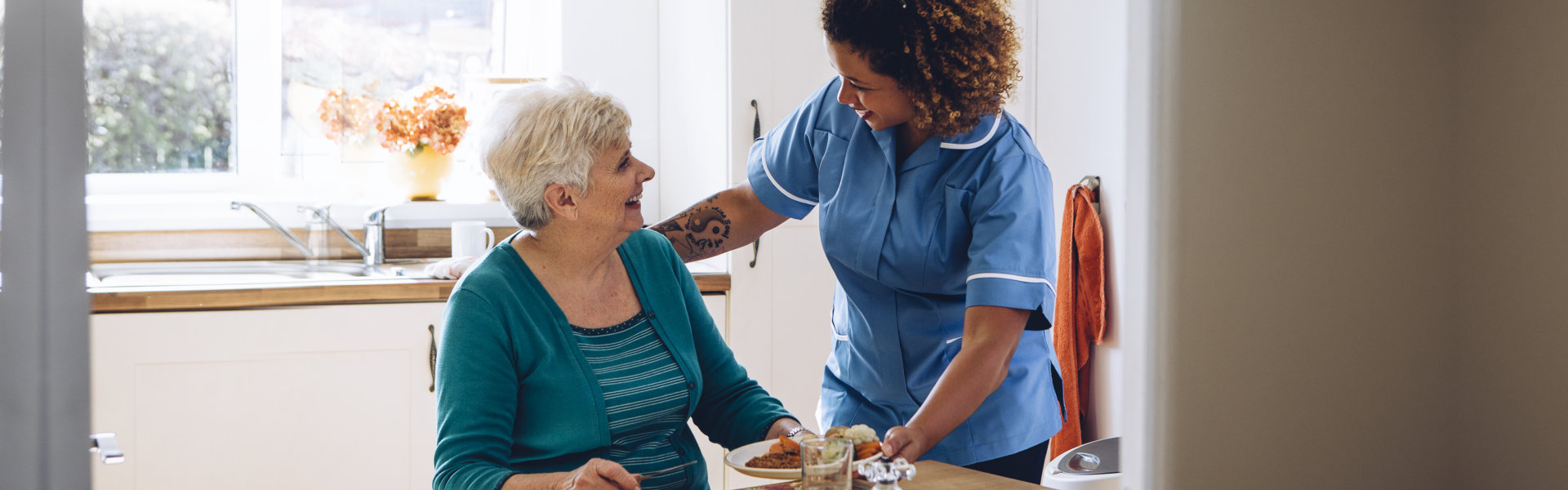 nurse preparing food for elderly woman