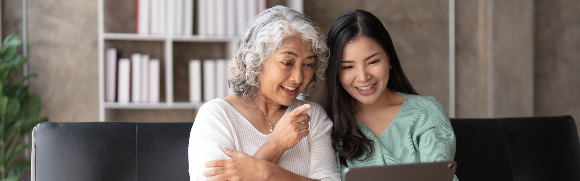 caregiver and elderly using a tablet